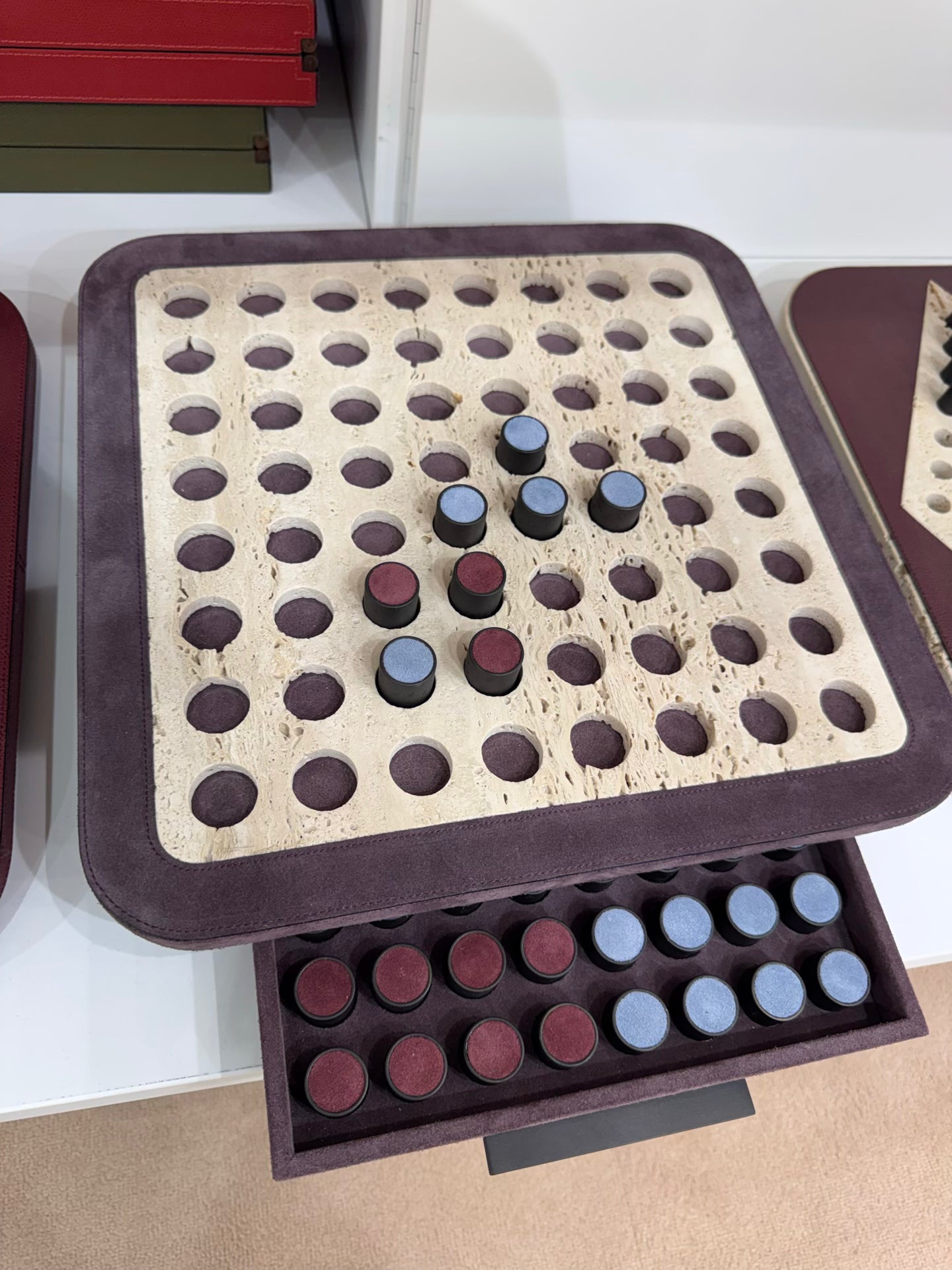 Giobagnara | Delos Othello Game Set Marble: Arabescato white or travertino leather-covered board with metal playing pieces and leather inserts | Game Room | 2Jour Concierge, your luxury lifestyle shop | luxury othello marble, Giobagnara Delos, marble game board, Italian designer game