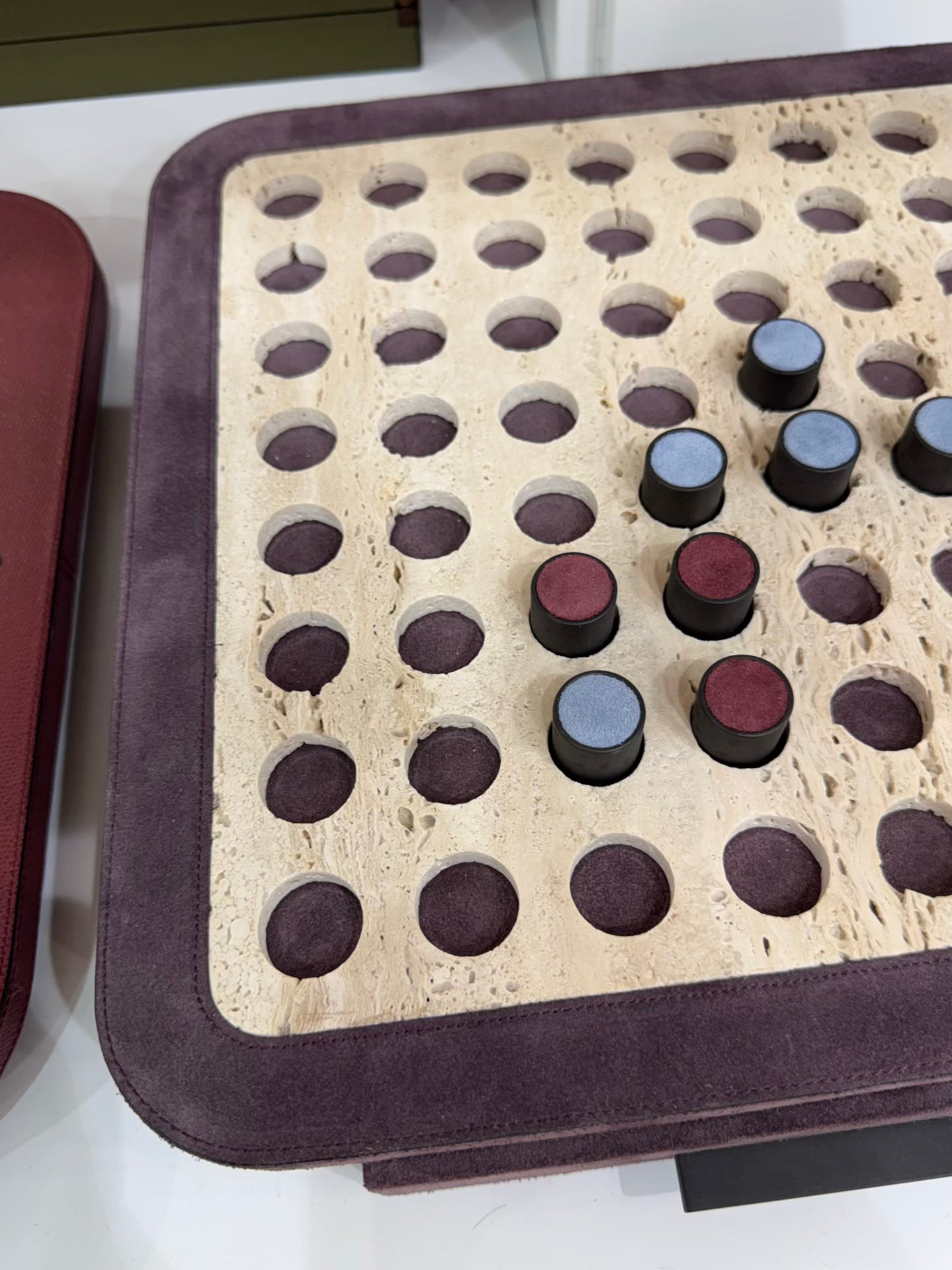 Giobagnara | Delos Othello Game Set Marble: Arabescato white or travertino leather-covered board with metal playing pieces and leather inserts | Game Room | 2Jour Concierge, your luxury lifestyle shop | luxury othello marble, Giobagnara Delos, marble game board, Italian designer game