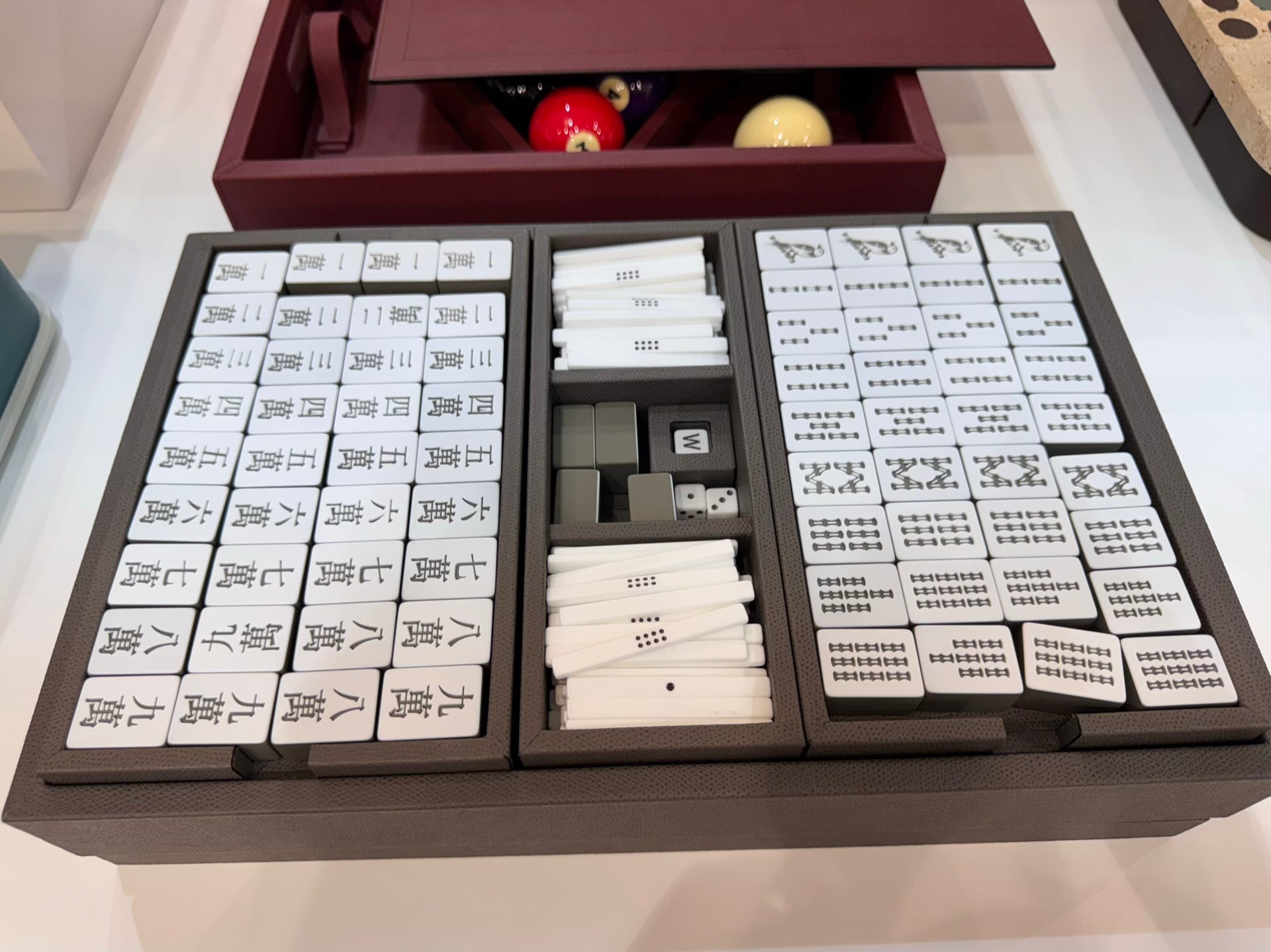 Giobagnara | Mahjong Game Set: Leather-covered wood case with opaque plexiglass tiles, sticks, and dice | Game Room | 2Jour Concierge, your luxury lifestyle shop | luxury mahjong set, Giobagnara mahjong, leather game case, Italian designer game, complete mahjong