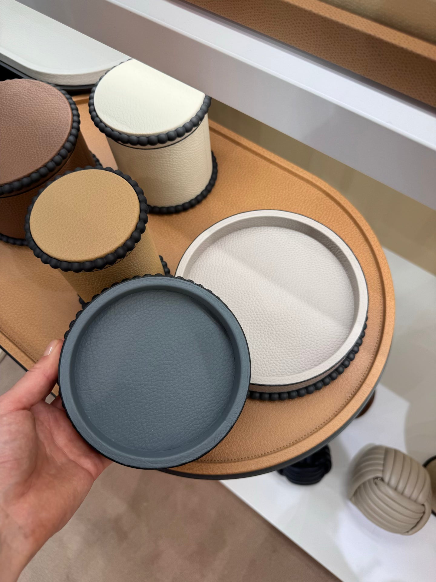 Giobagnara | Perla Round Valet Tray: Leather-covered round form with metal ring of linked spheres in chrome, bronze, or brass | Decor | 2Jour Concierge, your luxury lifestyle shop | luxury valet tray, Giobagnara Perla, round leather tray, Italian luxury decor, designer catch-all tray