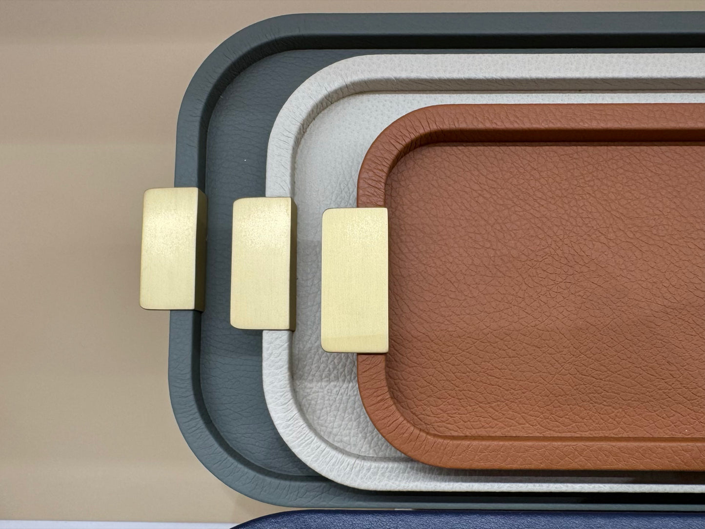 Giobagnara | Puccini Long Rectangular Tray: Leather-covered wood tray with metal handles in chrome, bronze, or brass | Serveware | 2Jour Concierge, your luxury lifestyle shop | luxury serving tray, Giobagnara Puccini, leather tray with handles, Italian designer tray, long rectangular tray