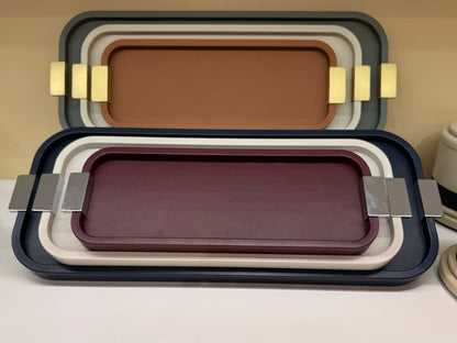 Giobagnara | Puccini Long Rectangular Tray: Leather-covered wood tray with metal handles in chrome, bronze, or brass | Serveware | 2Jour Concierge, your luxury lifestyle shop | luxury serving tray, Giobagnara Puccini, leather tray with handles, Italian designer tray, long rectangular tray
