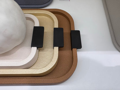 Giobagnara | Puccini Long Rectangular Tray: Leather-covered wood tray with metal handles in chrome, bronze, or brass | Serveware | 2Jour Concierge, your luxury lifestyle shop | luxury serving tray, Giobagnara Puccini, leather tray with handles, Italian designer tray, long rectangular tray