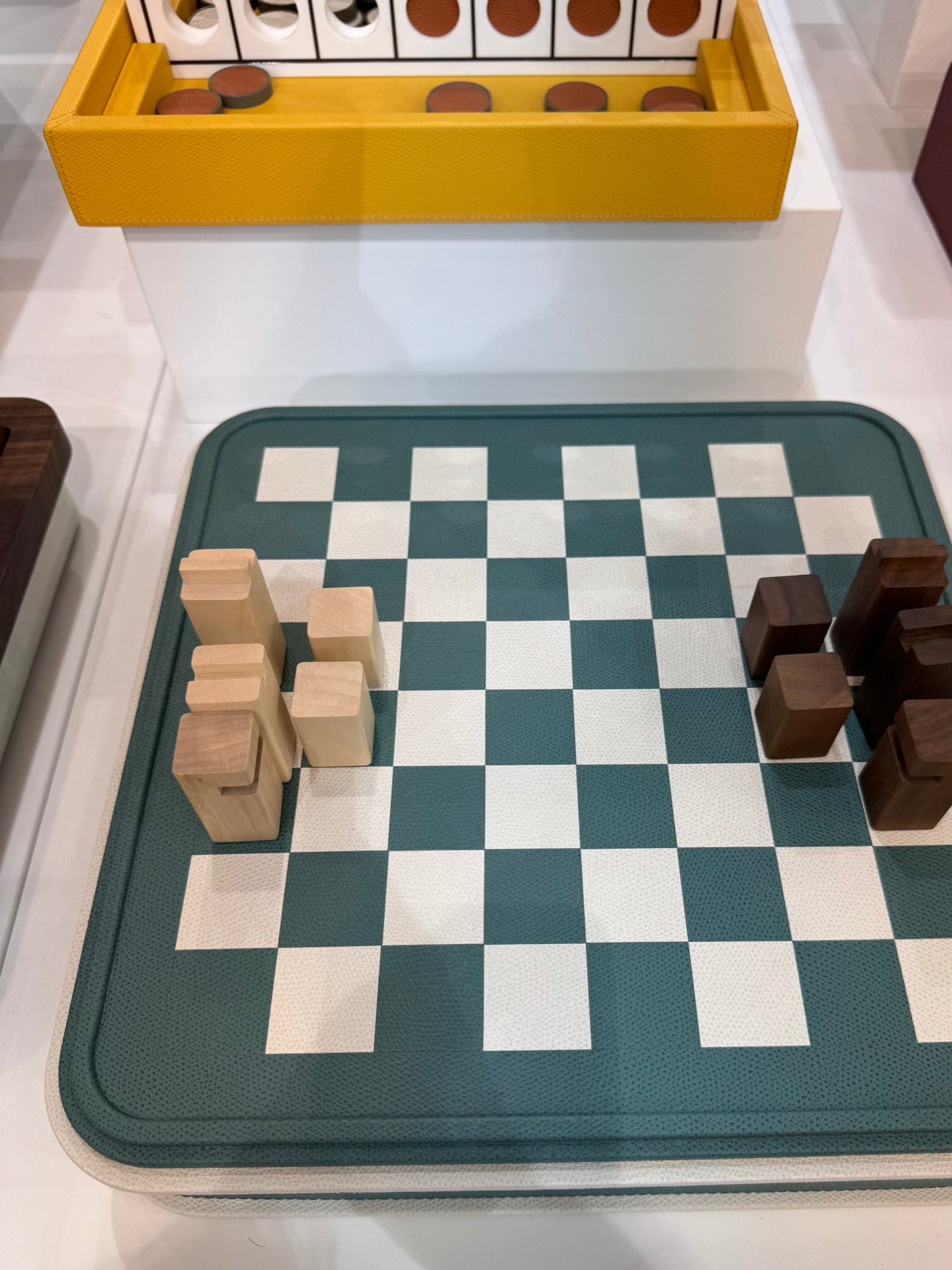 Giobagnara | Rolli Chess and Draughts Set: Leather-covered case with marquetry lid, maple and walnut pieces, leather-inlaid draughts | Game Room | 2Jour Concierge, your luxury lifestyle shop | luxury chess set, Giobagnara Rolli, leather chess board, Italian designer game set, luxury board game