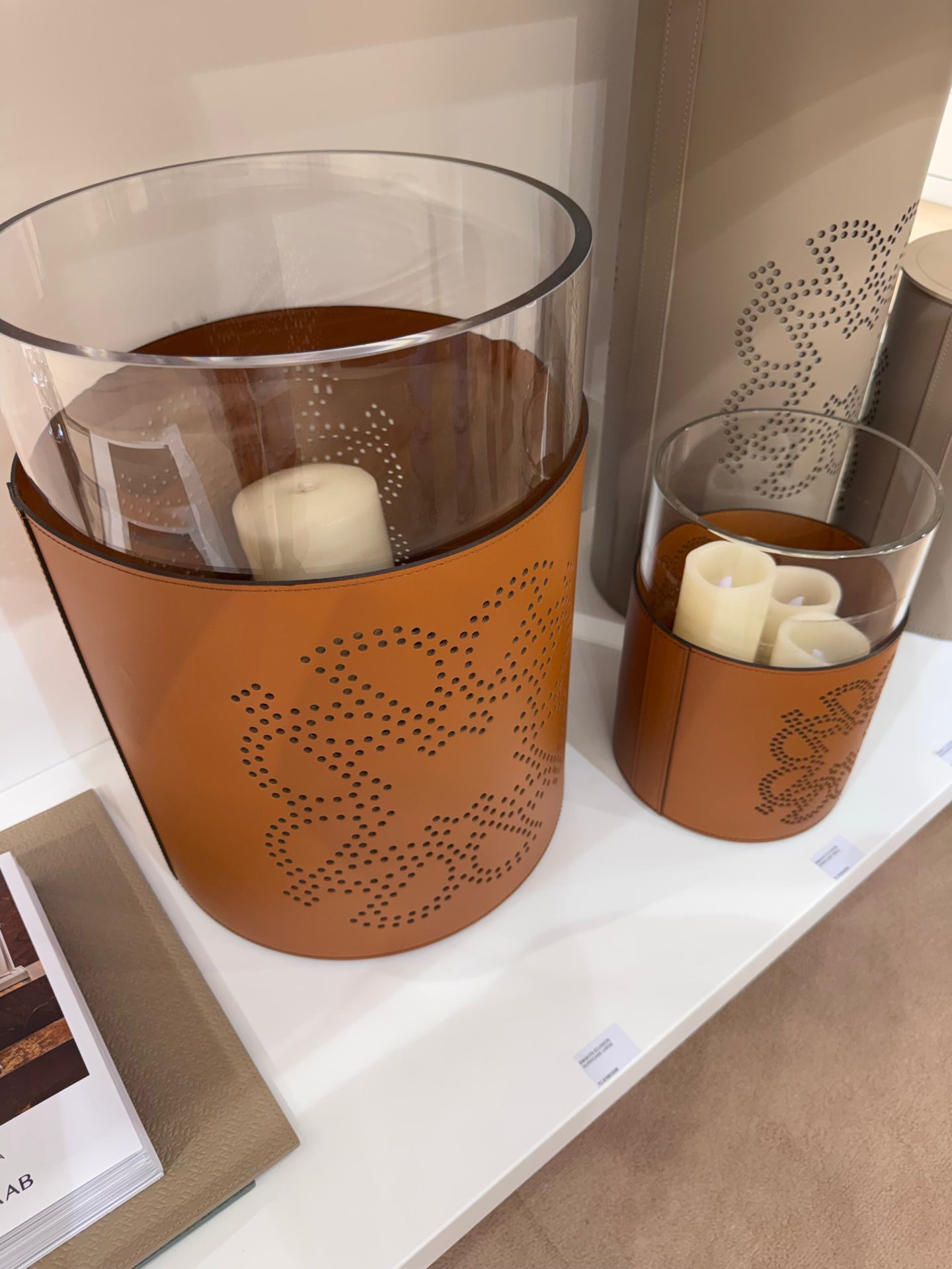 Giobagnara  ×  Elie Saab | Ecusson Hurricane: Borosilicate glass with frosted decorations and Tecnocuoio® with perforated Elie Saab Monogram — small and large | Decor | 2Jour Concierge, your luxury lifestyle shop | luxury hurricane candle holder, Giobagnara Elie Saab, leather hurricane lamp, designer candle lantern