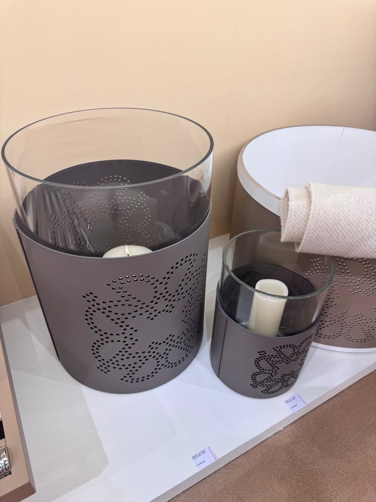Giobagnara  ×  Elie Saab | Ecusson Hurricane: Borosilicate glass with frosted decorations and Tecnocuoio® with perforated Elie Saab Monogram — small and large | Decor | 2Jour Concierge, your luxury lifestyle shop | luxury hurricane candle holder, Giobagnara Elie Saab, leather hurricane lamp, designer candle lantern