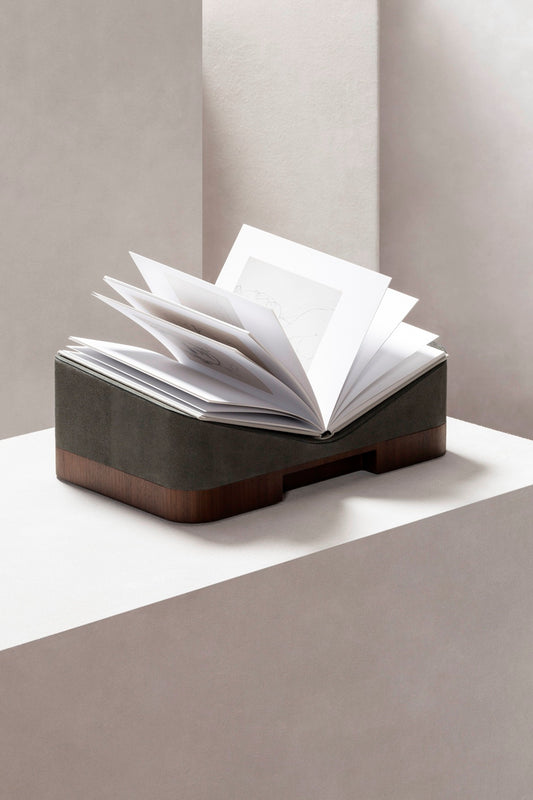 Giobagnara x Glenn Sestig Lloyd Bookstand | Versatile bookstand crafted in luxurious leather and solid wood—choose between dark-stained Canaletto walnut or wenge finishes—and also available in leather with travertine marble or full travertine marble constructions | Crafted in Italy by Giobagnara in collaboration with designer Glenn Sestig | Home Decor / Desk Accessories | 2Jour Concierge, your luxury lifestyle shop


