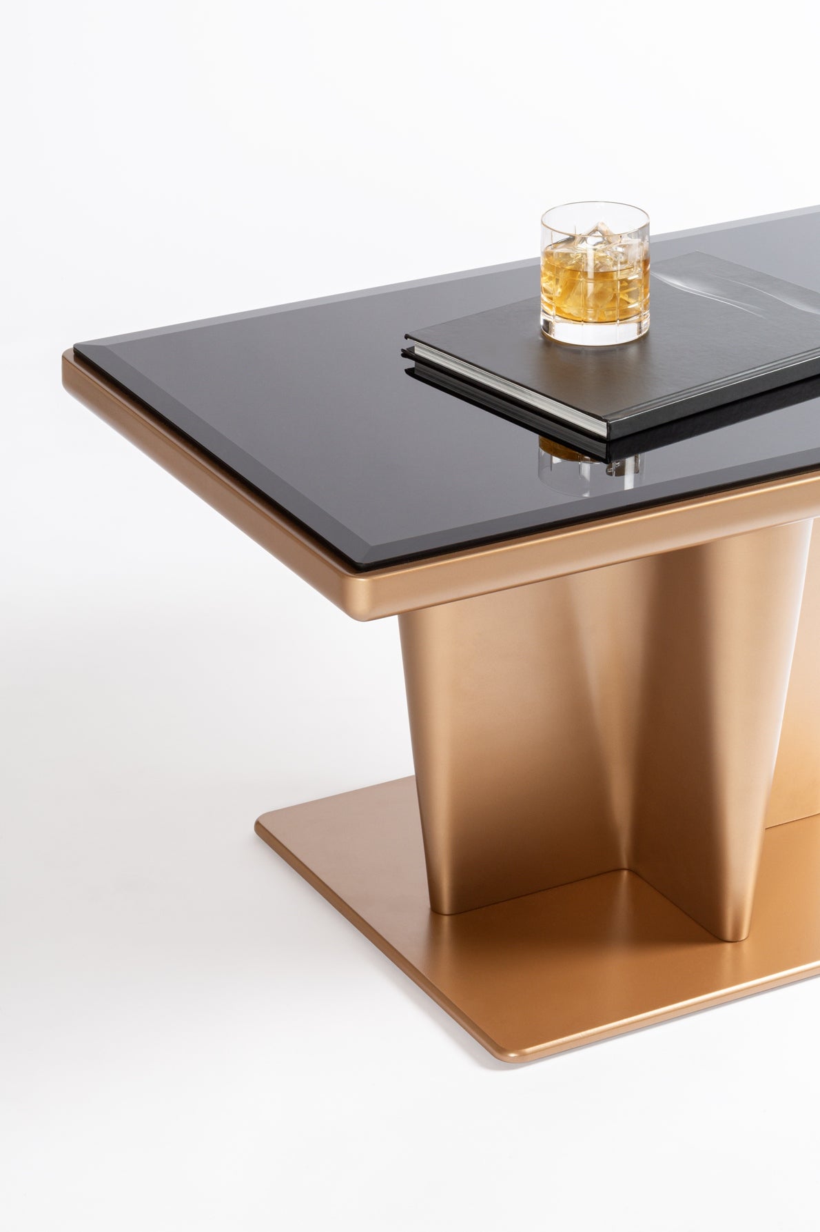 Giobagnara x Glenn Sestig Tanell Bar Table | Minimalist, contemporary design with a trilobed base tapered downward, an iconic piece and ideal display unit | Raw bronze or dark bronze-lacquered wood structure with bronze-colored glass top insert | Furniture and Bar Tables | 2Jour Concierge, your luxury lifestyle shop