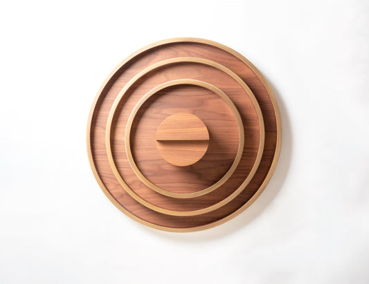 Riviere Dama | Round Tray: Wood and leather construction available in multiple sizes and finishes, designed for refined serving and decorative use | Serveware + Hospitality / Trays | 2Jour Concierge, your luxury lifestyle shop | luxury interiors, hospitality décor, elegant living, designer serveware, boutique hotels, refined lifestyle, yacht décor
