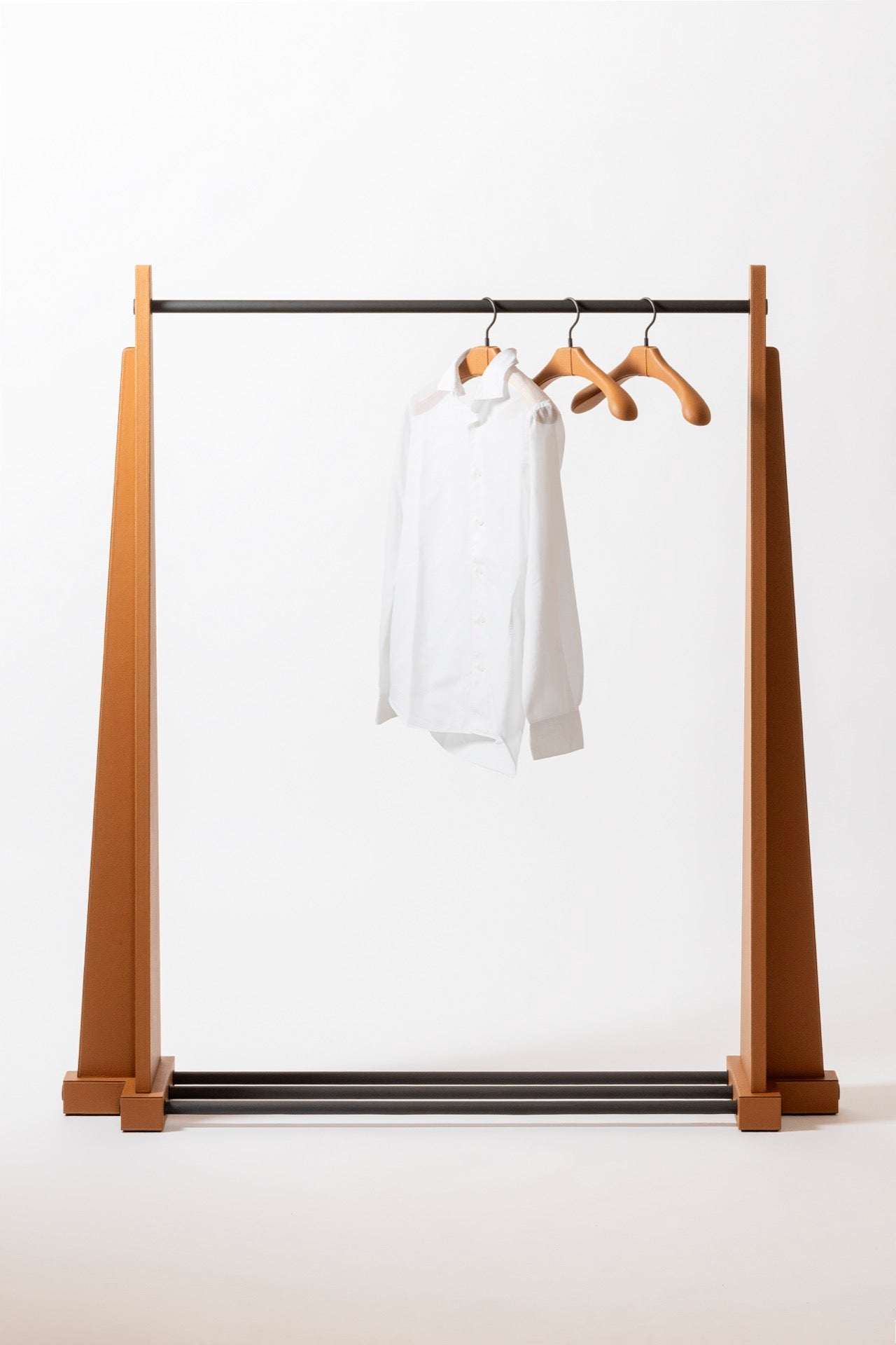Giobagnara | Edoardo Clothes Rack: Leather-covered wood clothes rack with metal hanging bar | Serveware + Hospitality / Clothes Valets | 2Jour Concierge, your luxury lifestyle shop | premium garment storage for expensive interiors, dressing rooms, hospitality suites, and refined retail spaces