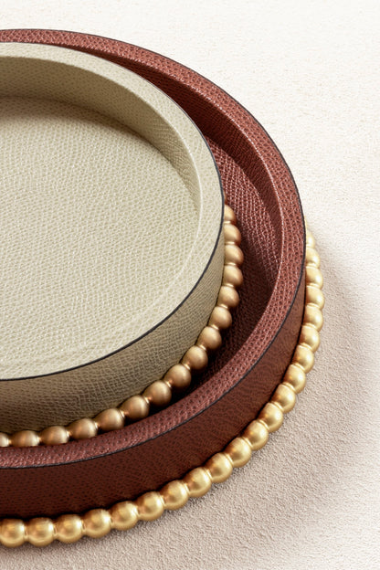 Giobagnara | Perla Round Valet Tray: Leather-covered round form with metal ring of linked spheres in chrome, bronze, or brass | Decor | 2Jour Concierge, your luxury lifestyle shop | luxury valet tray, Giobagnara Perla, round leather tray, Italian luxury decor, designer catch-all tray