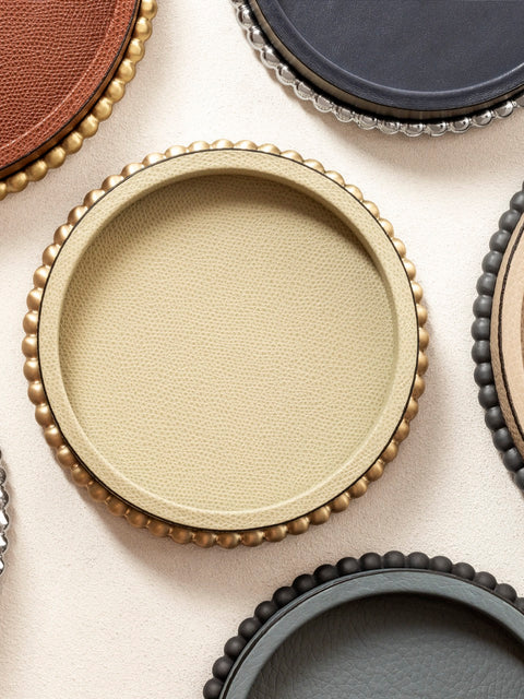 Giobagnara | Perla Round Valet Tray: Leather-covered round form with metal ring of linked spheres in chrome, bronze, or brass | Decor | 2Jour Concierge, your luxury lifestyle shop | luxury valet tray, Giobagnara Perla, round leather tray, Italian luxury decor, designer catch-all tray