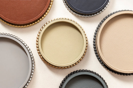 Giobagnara | Perla Round Valet Tray: Leather-covered round form with metal ring of linked spheres in chrome, bronze, or brass | Decor | 2Jour Concierge, your luxury lifestyle shop | luxury valet tray, Giobagnara Perla, round leather tray, Italian luxury decor, designer catch-all tray