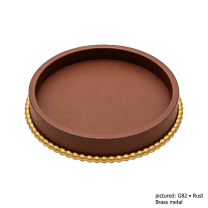 Giobagnara | Perla Round Valet Tray: Leather-covered round form with metal ring of linked spheres in chrome, bronze, or brass | Decor | 2Jour Concierge, your luxury lifestyle shop | luxury valet tray, Giobagnara Perla, round leather tray, Italian luxury decor, designer catch-all tray