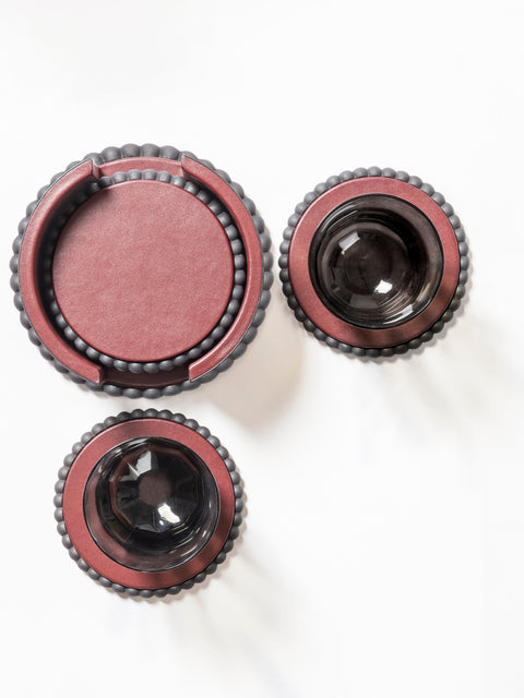 Giobagnara | Perla Round Coaster: Leather-covered round coaster with sculptural edge, available individually or with holder and set of six | Serveware + Hospitality / Coasters | 2Jour Concierge, your luxury lifestyle shop | luxury table details, premium coasters for expensive interiors, coffee tables, dining settings, and curated entertaining spaces