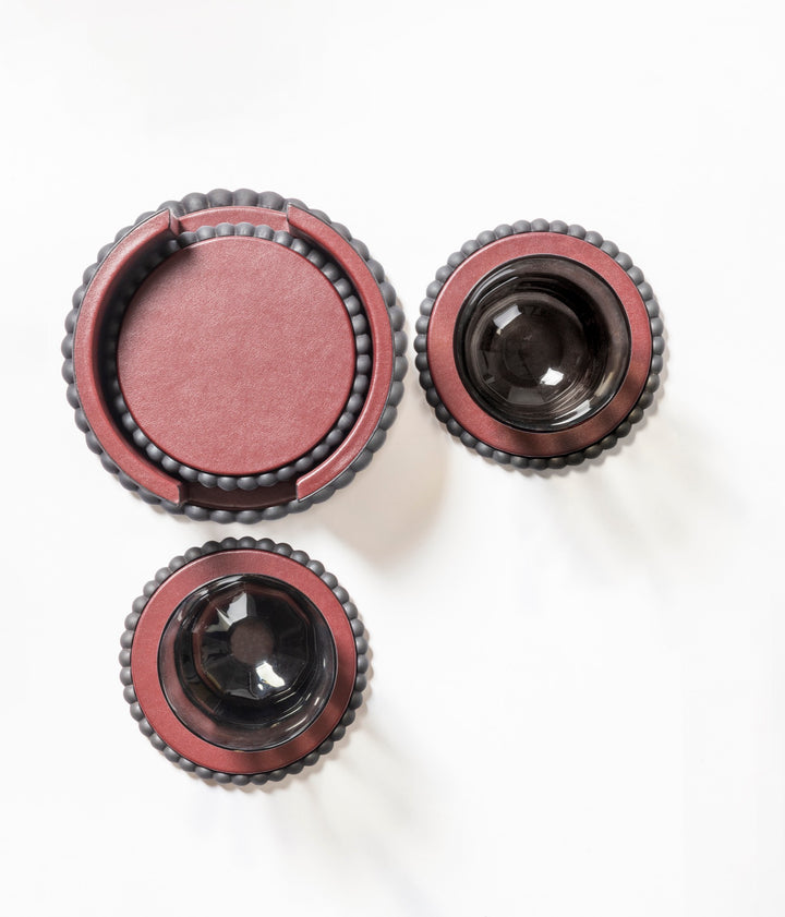 Giobagnara | Perla Round Coaster: Leather-covered round coaster with sculptural edge, available individually or with holder and set of six | Serveware + Hospitality / Coasters | 2Jour Concierge, your luxury lifestyle shop | luxury table details, premium coasters for expensive interiors, coffee tables, dining settings, and curated entertaining spaces