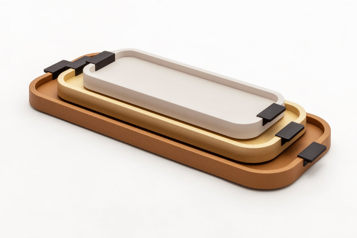 Giobagnara | Puccini Long Rectangular Tray: Leather-covered wood tray with metal handles in chrome, bronze, or brass | Serveware | 2Jour Concierge, your luxury lifestyle shop | luxury serving tray, Giobagnara Puccini, leather tray with handles, Italian designer tray, long rectangular tray