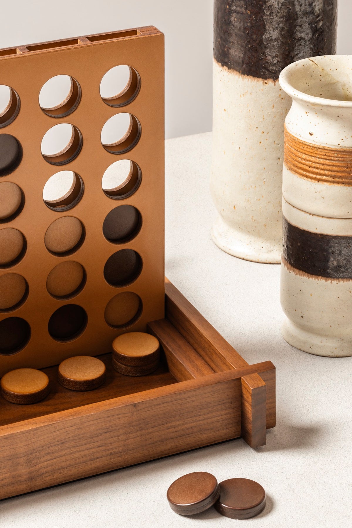 Giobagnara | Structura Connect Four Game Set: Wood structure with sole leather playing field and chips in brown and natural | Game Room | 2Jour Concierge, your luxury lifestyle shop | luxury connect four, Giobagnara Structura, sole leather game set, Italian designer game