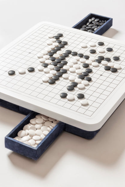 Giobagnara | Delos Go Game Set Corian®: Corian® top with digital-printed leather playing field and Corian® beads | Game Room | 2Jour Concierge, your luxury lifestyle shop | luxury go game Corian, Giobagnara Delos, Corian game board, Italian designer game set