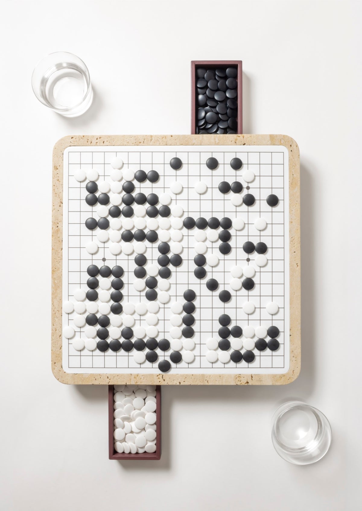 Giobagnara | Delos Go Game Set Marble: Arabescato white or travertino top with digital-printed leather playing field and Corian® beads | Game Room | 2Jour Concierge, your luxury lifestyle shop | luxury go game marble, Giobagnara Delos, marble game board, Italian designer game set