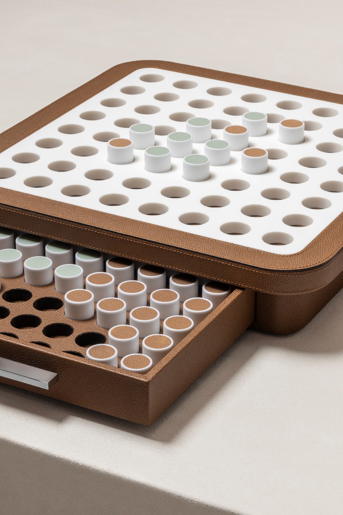 Giobagnara | Delos Othello Game Set Corian®: Corian® leather-covered board with Corian® playing pieces and leather inserts | Game Room | 2Jour Concierge, your luxury lifestyle shop | luxury othello Corian, Giobagnara Delos, Corian game board, Italian designer game