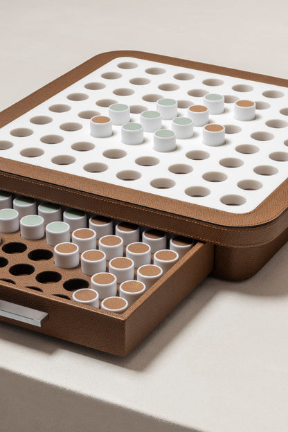 Giobagnara | Delos Othello Game Set Corian®: Corian® leather-covered board with Corian® playing pieces and leather inserts | Game Room | 2Jour Concierge, your luxury lifestyle shop | luxury othello Corian, Giobagnara Delos, Corian game board, Italian designer game