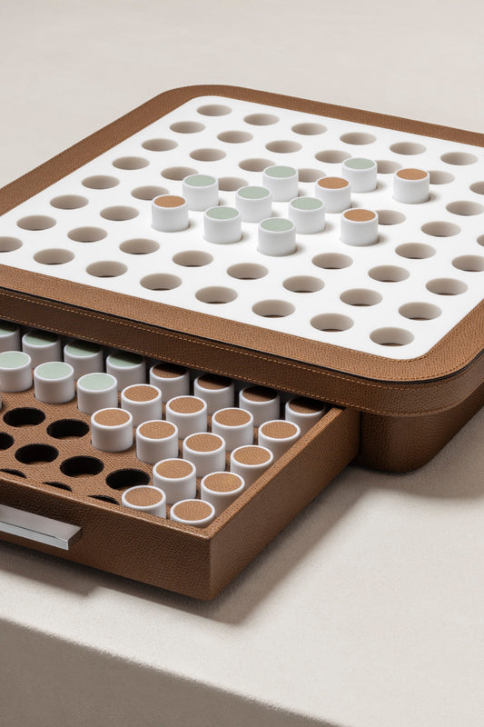 Giobagnara | Delos Othello Game Set Corian®: Corian® leather-covered board with Corian® playing pieces and leather inserts | Game Room | 2Jour Concierge, your luxury lifestyle shop | luxury othello Corian, Giobagnara Delos, Corian game board, Italian designer game