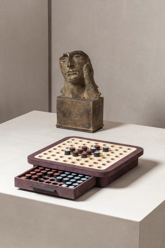 Giobagnara | Delos Othello Game Set Marble: Arabescato white or travertino leather-covered board with metal playing pieces and leather inserts | Game Room | 2Jour Concierge, your luxury lifestyle shop | luxury othello marble, Giobagnara Delos, marble game board, Italian designer game