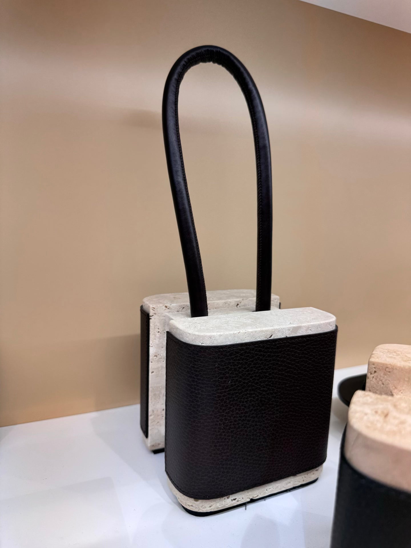 Giobagnara x Glenn Sestig Lloyd Leather & Marble Doorstop | Collaboration with Glenn Sestig | Stylish Design with Leather and Travertine | Leather Handle Available in Nappa Only | Explore a Range of Luxury Home Accessories at 2Jour Concierge, #1 luxury high-end gift & lifestyle shop