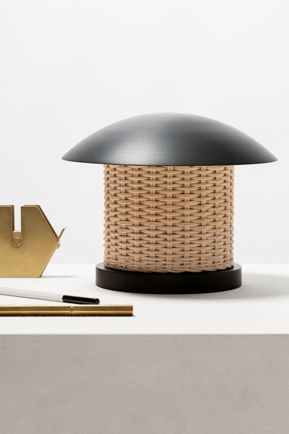 Giobagnara x Stéphane Parmentier Duomo Table Lamp | Vintage-inspired Design with Modern Minimalism | Sculptural Appearance with Geometrical Volumes | Crafted with Curved Bronze Lampshades and Woven Rattan Bases | Casts Soft Ambient Light for Reading and Lounging | Available at 2Jour Concierge, #1 luxury high-end gift & lifestyle shop