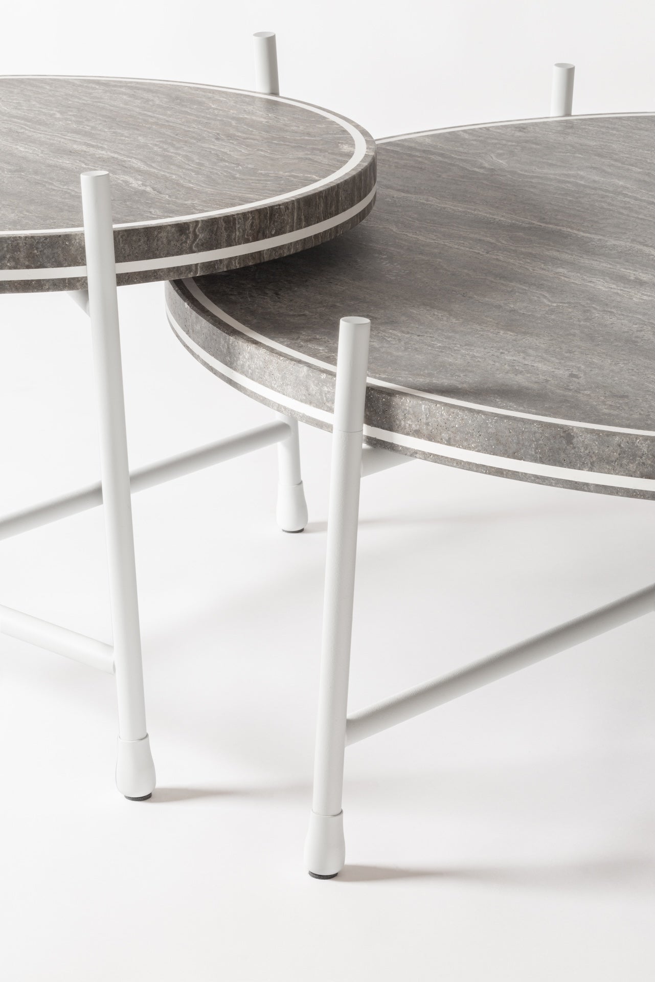 Giobagnara × Stéphane Parmentier Oblivion | Round Travertine Coffee Table: Travertine top with slim metal legs in bronze or white, available in classic or titanium finishes | Furniture / Coffee Tables | 2Jour Concierge, your luxury lifestyle shop | luxury interiors, elegant living, hospitality décor, boutique hotels, yacht décor, executive offices, refined lifestyle