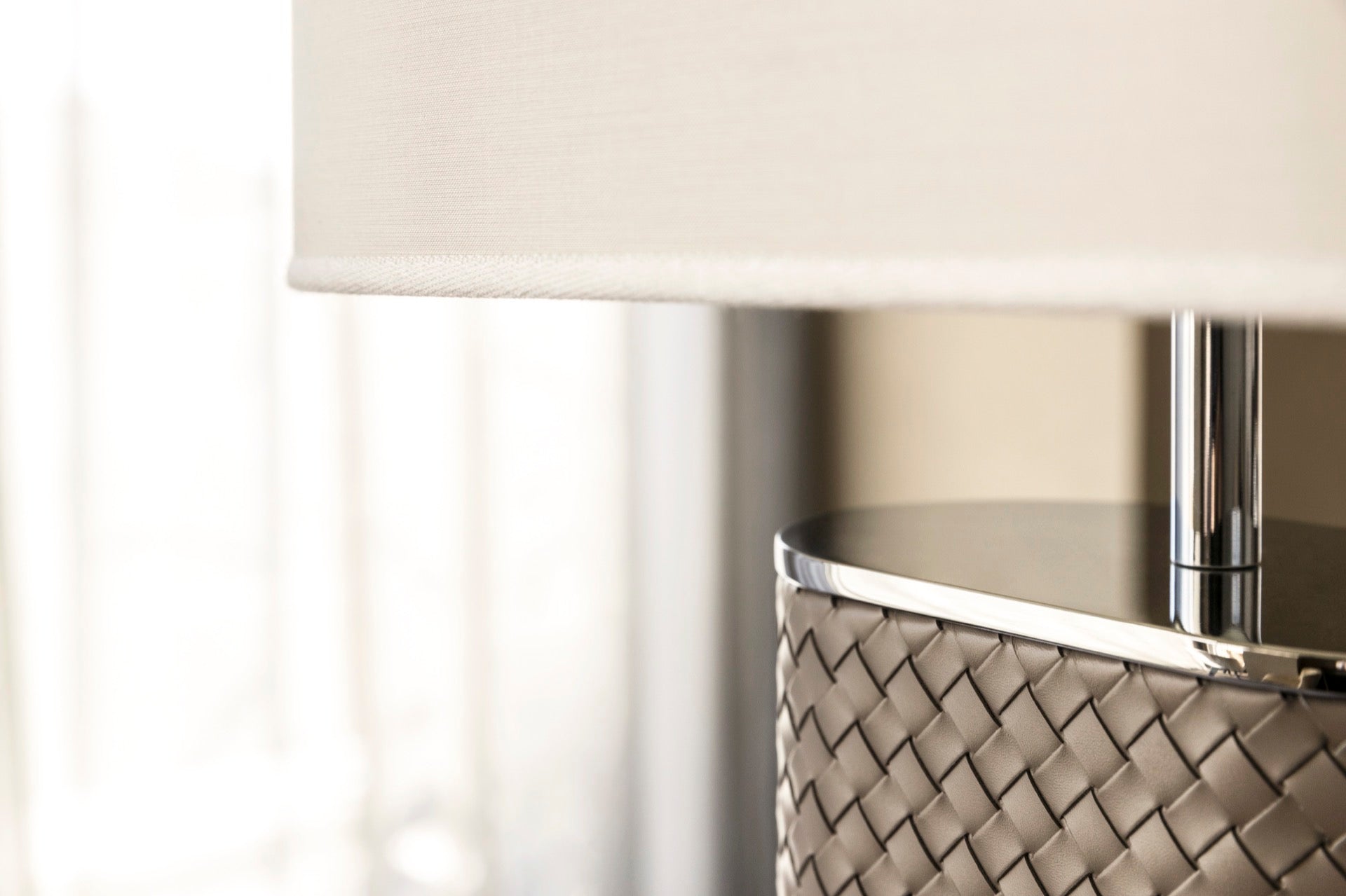 Riviere Flavia | Table Lamp: Leather-covered cylindrical base with optional braided, handwoven, or herringbone patterns, chrome or gold metal finishes, designed for refined contemporary interiors | Lighting / Table Lamps | 2Jour Concierge, your luxury lifestyle shop | luxury interiors, hospitality décor, elegant living, designer lighting, boutique hotels, refined lifestyle, yacht décor