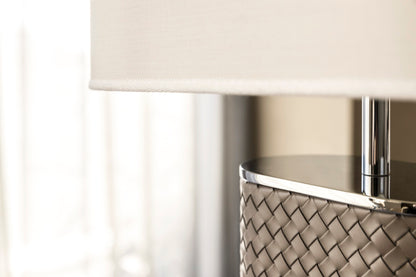 Riviere Flavia | Table Lamp: Leather-covered cylindrical base with optional braided, handwoven, or herringbone patterns, chrome or gold metal finishes, designed for refined contemporary interiors | Lighting / Table Lamps | 2Jour Concierge, your luxury lifestyle shop | luxury interiors, hospitality décor, elegant living, designer lighting, boutique hotels, refined lifestyle, yacht décor