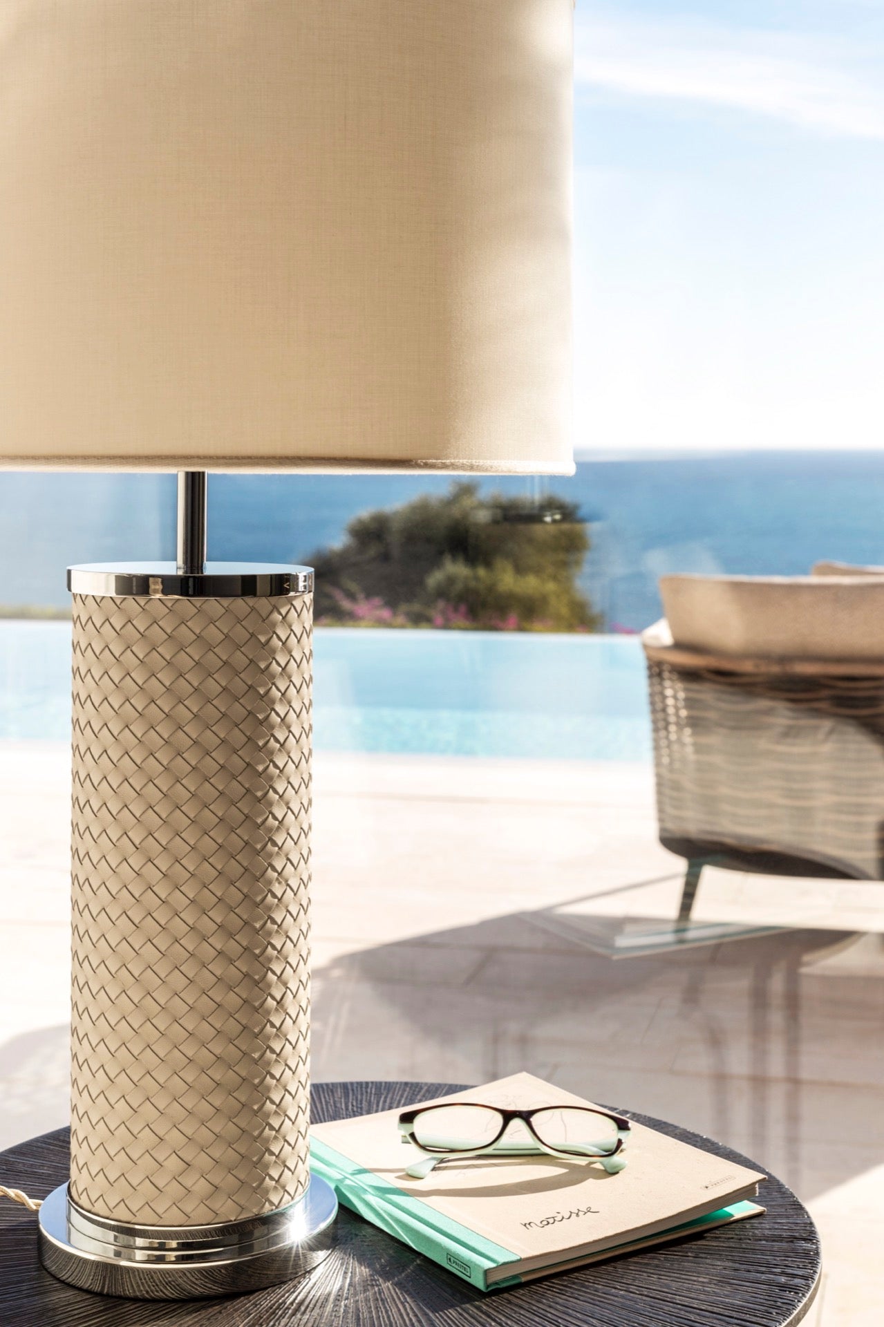 Riviere Flavia | Table Lamp: Leather-covered cylindrical base with optional braided, handwoven, or herringbone patterns, chrome or gold metal finishes, designed for refined contemporary interiors | Lighting / Table Lamps | 2Jour Concierge, your luxury lifestyle shop | luxury interiors, hospitality décor, elegant living, designer lighting, boutique hotels, refined lifestyle, yacht décor