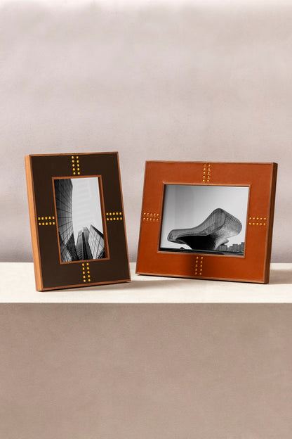 Rabitti 1969 | Toiles de Noyer Walnut Wood and Saddle Leather Picture Frame N°1: Walnut wood picture frame with saddle leather inserts and golden tacks, two sizes, magnetic back | Decor | 2Jour Concierge, your luxury lifestyle shop | luxury picture frame, Rabitti 1969, Toiles de Noyer, walnut leather frame, golden tack detail, Italian luxury decor, designer photo frame, Giobagnara leather frame