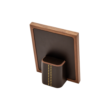 Rabitti 1969 | Toiles de Noyer Walnut Wood and Saddle Leather Picture Frame N°1: Walnut wood picture frame with saddle leather inserts and golden tacks, two sizes, magnetic back | Decor | 2Jour Concierge, your luxury lifestyle shop | luxury picture frame, Rabitti 1969, Toiles de Noyer, walnut leather frame, golden tack detail, Italian luxury decor, designer photo frame, Giobagnara leather frame