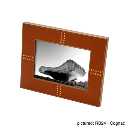 Rabitti 1969 | Toiles de Noyer Walnut Wood and Saddle Leather Picture Frame N°1: Walnut wood picture frame with saddle leather inserts and golden tacks, two sizes, magnetic back | Decor | 2Jour Concierge, your luxury lifestyle shop | luxury picture frame, Rabitti 1969, Toiles de Noyer, walnut leather frame, golden tack detail, Italian luxury decor, designer photo frame, Giobagnara leather frame