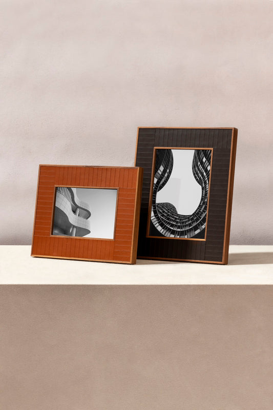 Rabitti 1969 | Toiles de Noyer Walnut Wood and Saddle Leather Picture Frame N°2: Walnut wood picture frame with saddle leather inserts engraved with vertical and horizontal stripes, two sizes, magnetic back | Decor | 2Jour Concierge, your luxury lifestyle shop | luxury picture frame, Rabitti 1969, Toiles de Noyer, walnut leather frame, engraved leather detail, Italian luxury decor, designer photo frame, Giobagnara leather frame
