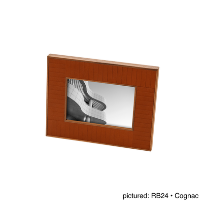 Rabitti 1969 | Toiles de Noyer Walnut Wood and Saddle Leather Picture Frame N°2: Walnut wood picture frame with saddle leather inserts engraved with vertical and horizontal stripes, two sizes, magnetic back | Decor | 2Jour Concierge, your luxury lifestyle shop | luxury picture frame, Rabitti 1969, Toiles de Noyer, walnut leather frame, engraved leather detail, Italian luxury decor, designer photo frame, Giobagnara leather frame