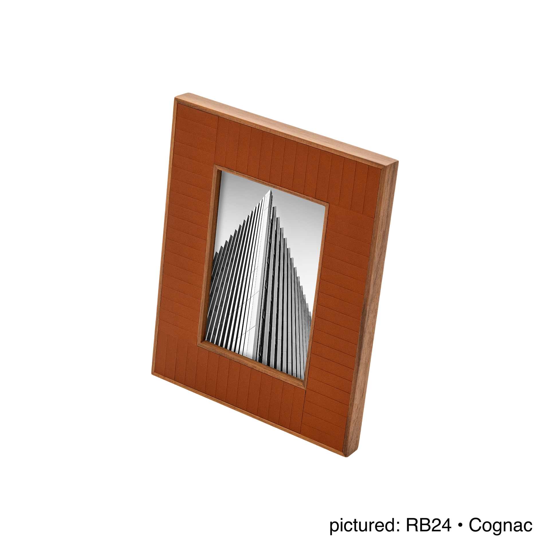 Rabitti 1969 | Toiles de Noyer Walnut Wood and Saddle Leather Picture Frame N°2: Walnut wood picture frame with saddle leather inserts engraved with vertical and horizontal stripes, two sizes, magnetic back | Decor | 2Jour Concierge, your luxury lifestyle shop | luxury picture frame, Rabitti 1969, Toiles de Noyer, walnut leather frame, engraved leather detail, Italian luxury decor, designer photo frame, Giobagnara leather frame