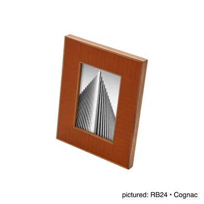 Rabitti 1969 | Toiles de Noyer Walnut Wood and Saddle Leather Picture Frame N°2: Walnut wood picture frame with saddle leather inserts engraved with vertical and horizontal stripes, two sizes, magnetic back | Decor | 2Jour Concierge, your luxury lifestyle shop | luxury picture frame, Rabitti 1969, Toiles de Noyer, walnut leather frame, engraved leather detail, Italian luxury decor, designer photo frame, Giobagnara leather frame
