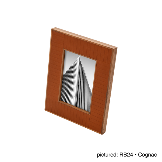Rabitti 1969 | Toiles de Noyer Walnut Wood and Saddle Leather Picture Frame N°2: Walnut wood picture frame with saddle leather inserts engraved with vertical and horizontal stripes, two sizes, magnetic back | Decor | 2Jour Concierge, your luxury lifestyle shop | luxury picture frame, Rabitti 1969, Toiles de Noyer, walnut leather frame, engraved leather detail, Italian luxury decor, designer photo frame, Giobagnara leather frame