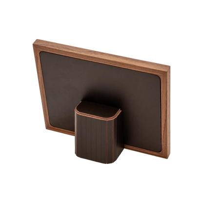 Rabitti 1969 | Toiles de Noyer Walnut Wood and Saddle Leather Picture Frame N°2: Walnut wood picture frame with saddle leather inserts engraved with vertical and horizontal stripes, two sizes, magnetic back | Decor | 2Jour Concierge, your luxury lifestyle shop | luxury picture frame, Rabitti 1969, Toiles de Noyer, walnut leather frame, engraved leather detail, Italian luxury decor, designer photo frame, Giobagnara leather frame