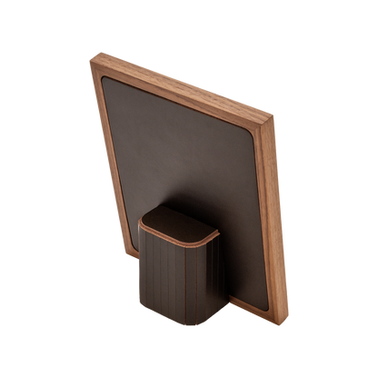 Rabitti 1969 | Toiles de Noyer Walnut Wood and Saddle Leather Picture Frame N°2: Walnut wood picture frame with saddle leather inserts engraved with vertical and horizontal stripes, two sizes, magnetic back | Decor | 2Jour Concierge, your luxury lifestyle shop | luxury picture frame, Rabitti 1969, Toiles de Noyer, walnut leather frame, engraved leather detail, Italian luxury decor, designer photo frame, Giobagnara leather frame
