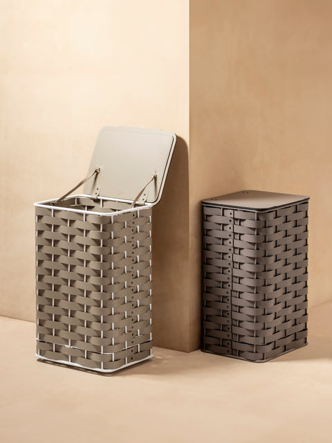 Rudi | Nassa Regular Laundry Basket: Dark-stained aluminum structure with Tecnocuoio® weaving — two sizes with or without lid, rubber feet or wheels | Storage | 2Jour Concierge, your luxury lifestyle shop | luxury laundry basket, Rudi Nassa, Tecnocuoio basket, designer laundry hamper, indoor outdoor basket
