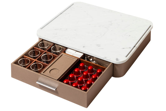 Giobagnara Saint-Germain deluxe coffee and tea drawer organizer + cups | Luxurious organizer for Nespresso classic capsules and tea service | Leather-covered wood structure with metal inserts in three finishes | Top customizable in leather, Corian®, or marble (classic travertine or arabescato white) | Inner walnut wood partitions hold coffee spoons, sugar, 24 capsules, 6 double-wall borosilicate glass cups, and 6 nesting rectangular saucers (all included) | Option to replace glass cups with sieger porcelain