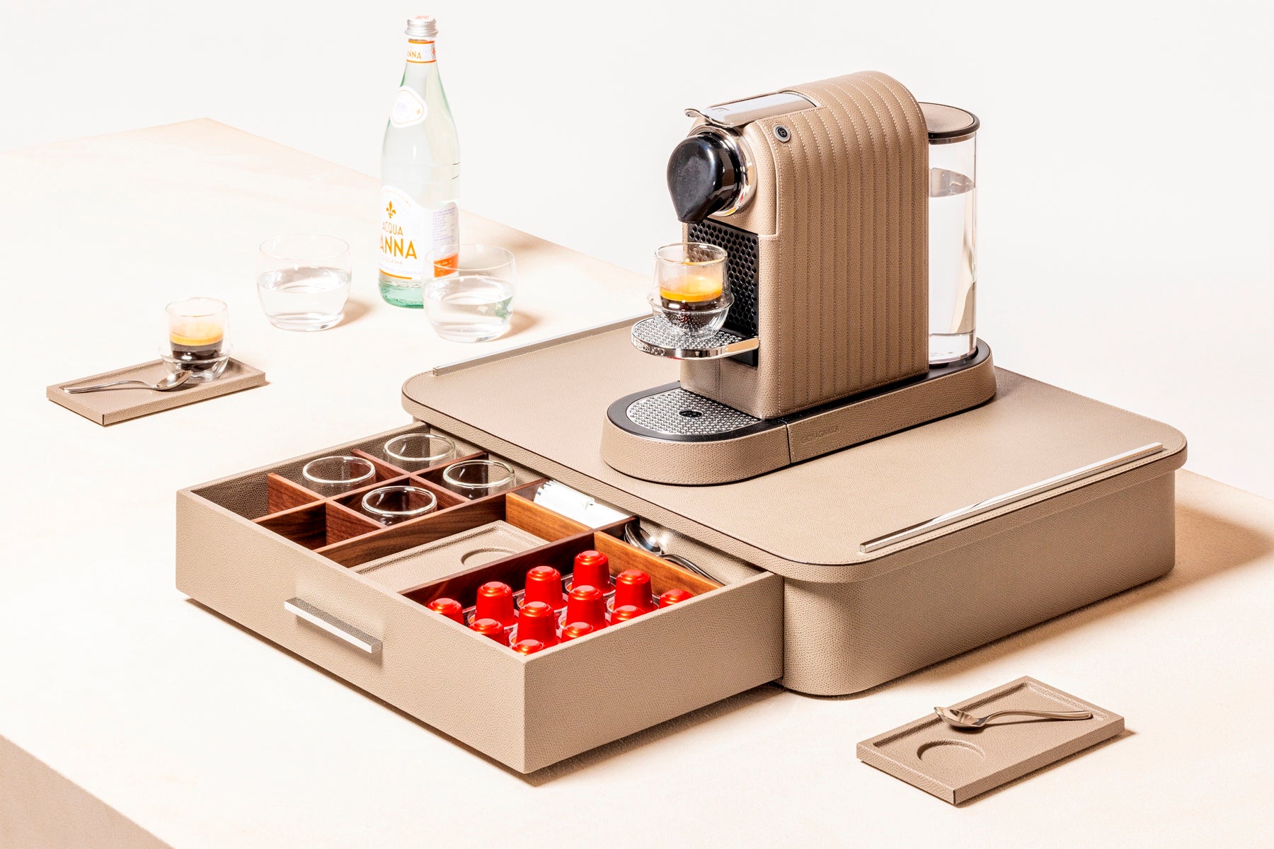 Giobagnara Saint-Germain deluxe coffee and tea drawer organizer + cups | Luxurious organizer for Nespresso classic capsules and tea service | Leather-covered wood structure with metal inserts in three finishes | Top customizable in leather, Corian®, or marble (classic travertine or arabescato white) | Inner walnut wood partitions hold coffee spoons, sugar, 24 capsules, 6 double-wall borosilicate glass cups, and 6 nesting rectangular saucers (all included) | Option to replace glass cups with sieger porcelain