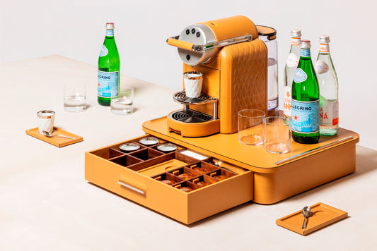 Giobagnara Saint-Germain deluxe coffee and tea drawer organizer + cups for professional capsules | Premium organizer for Nespresso professional capsules and full beverage service | Leather-covered wood structure with metal inserts in three finishes | Top customizable in leather, Corian®, or marble (classic travertine or arabescato white) | Inner walnut wood partitions hold coffee spoons, sugar, 30 capsules, 6 double-wall borosilicate glass cups, and 6 nesting rectangular saucers (all included) | Glass cups 