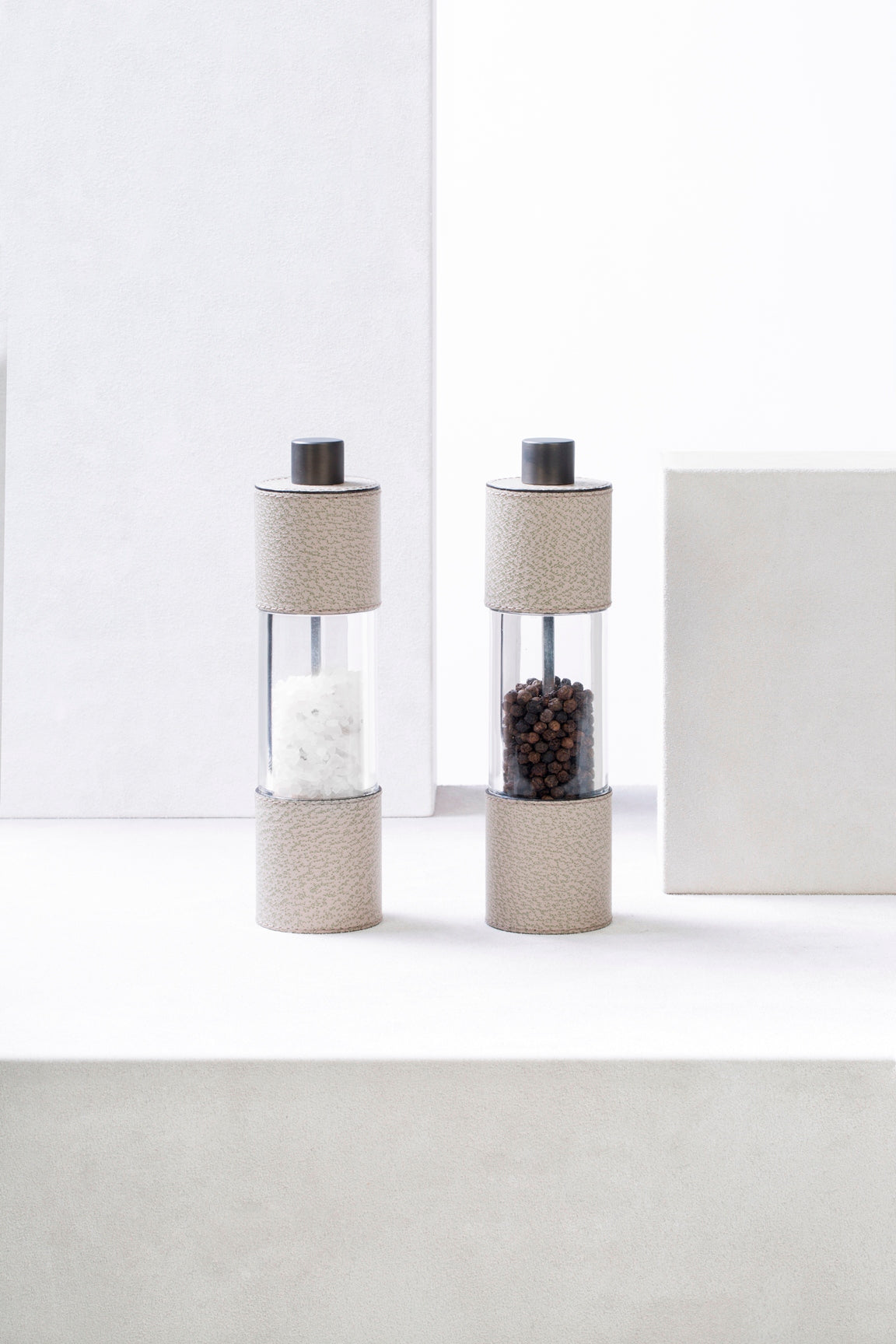Giobagnara Otello Manual Tall Salt Mill | Leather-covered stainless steel structure with a metal knob and premium ceramic grinder, providing continuous fine-to-coarse adjustment for elevated salt service | Serveware & Accessories / Kitchen Tools | 2Jour Concierge, your luxury lifestyle shop