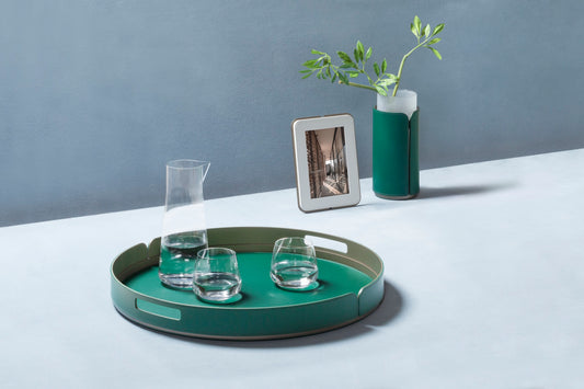 Rudi Tour | Round Tray: Regenerated leather with aluminum base and smooth, matte finish, designed by Adam D. Tihany, available in multiple sizes, suitable for serving and presentation | Serveware & Hospitality / Trays | 2Jour Concierge, your luxury lifestyle shop